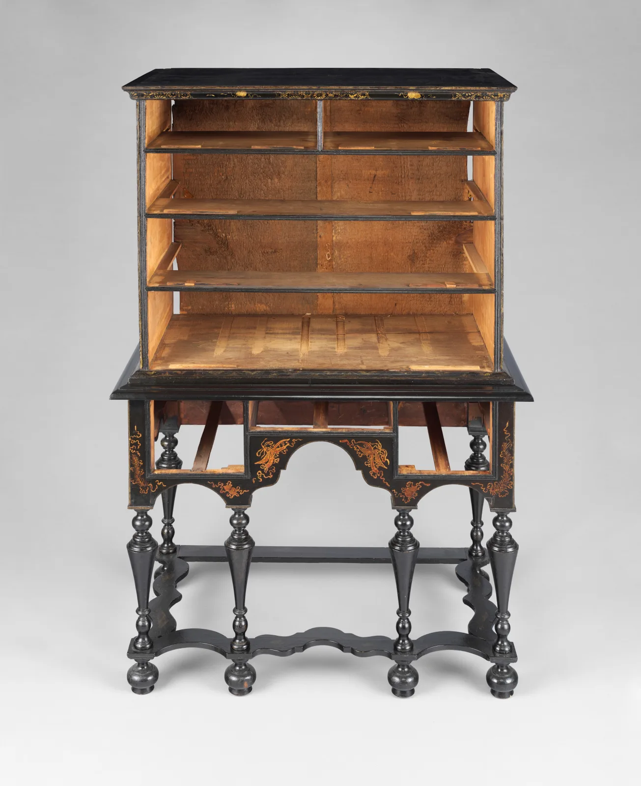 Front of the same high chest with every drawer removed, showing pale unfinished wood inside the case and drawer dividers edged in black