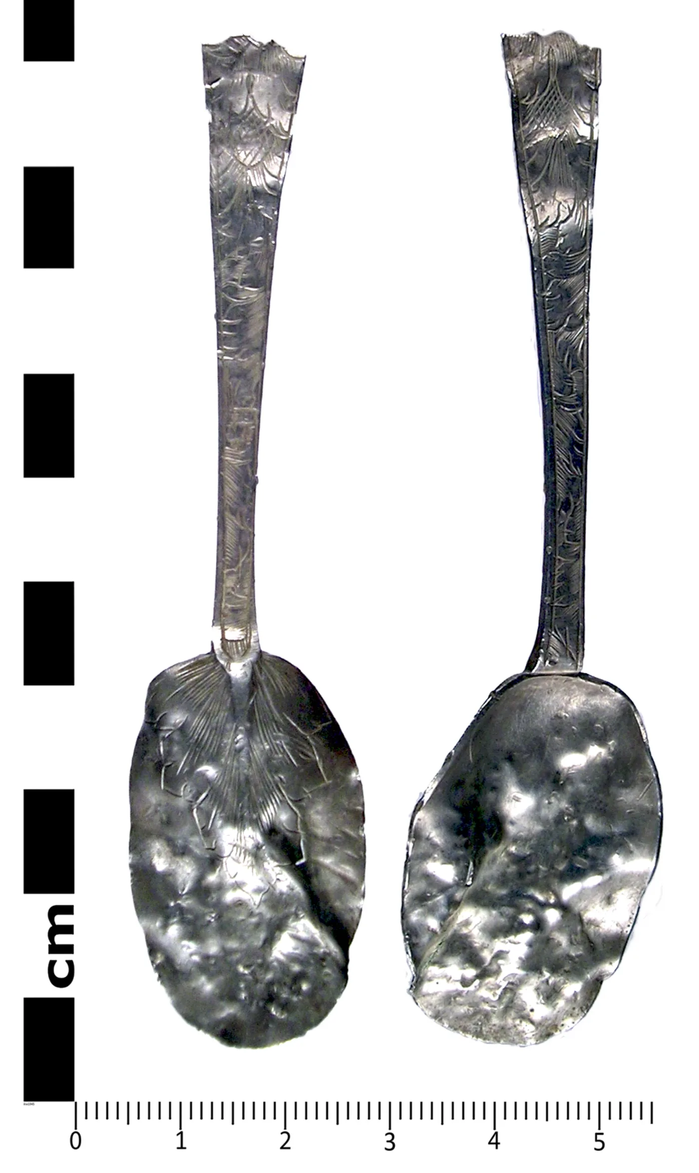 Late seventeenth-century English silver spoon shown front and back, with chased decoration and a ribbed rat-tail running down the back of the bowl