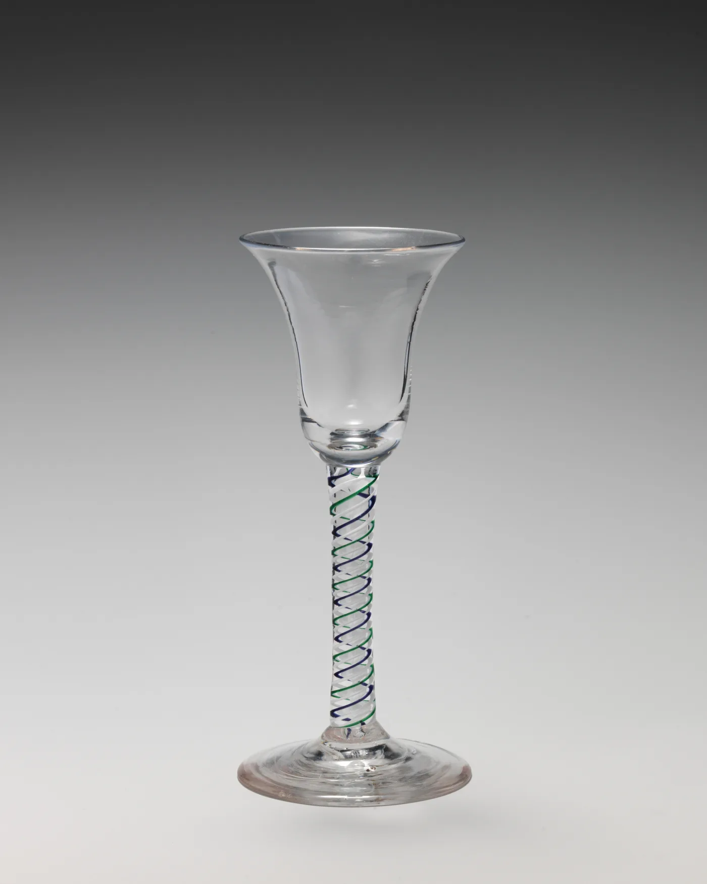 English colour twist wine glass with one blue thread and one green thread wound together through a clear stem below a bell bowl