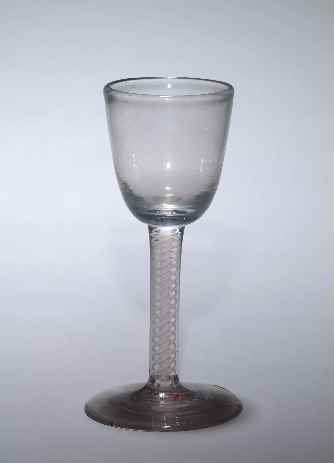 English opaque white twist wine glass of about 1750 to 1780 with a bucket bowl and a fine multi-ply white cable in the stem