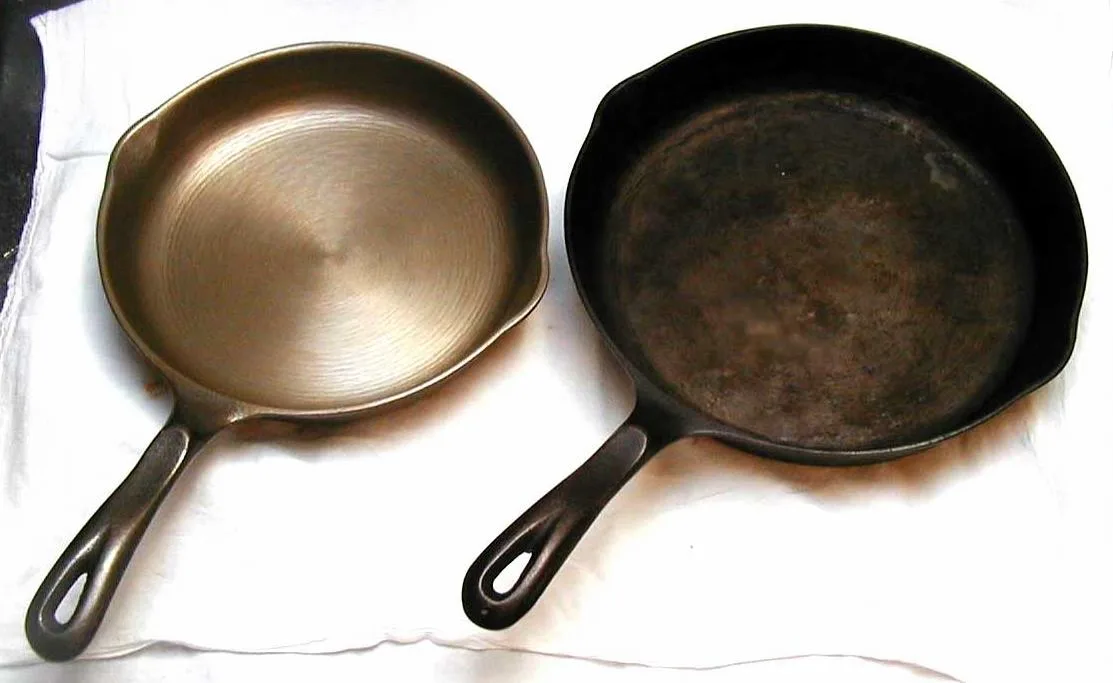 Two cast iron skillets side by side on a white cloth, the left one with a smooth light cooking surface and the right one darker with a rougher surface