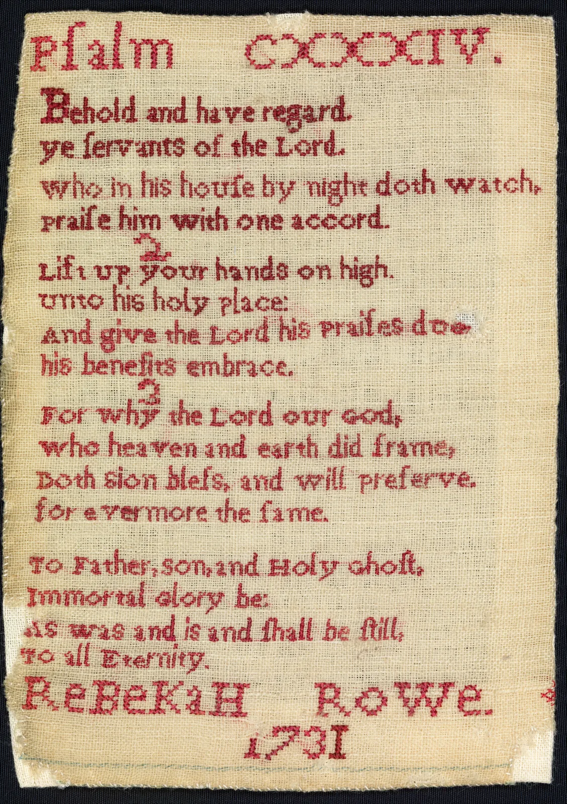 Small linen sampler worked entirely in red cross stitch with the heading Psalm CXXXIV, three numbered verses, a doxology and the name Rebekah Rowe 1731
