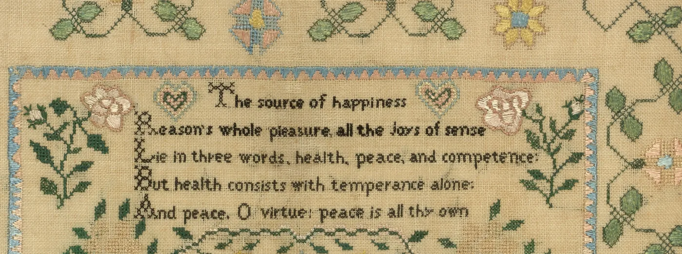 Close view of a stitched verse: The source of happiness. Reason's whole pleasure, all the joys of sense, Lie in three words, health, peace, and competence
