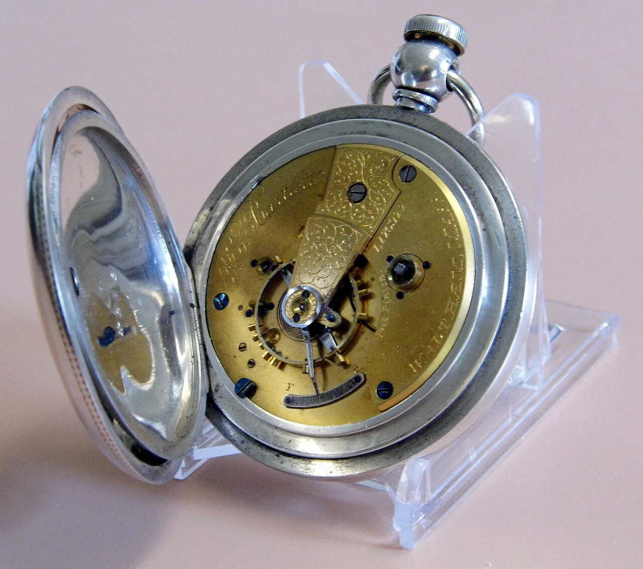 Gilt brass pocket watch movement with an engraved balance cock, the grade name Bartlett in script and Waltham engraved around the edge