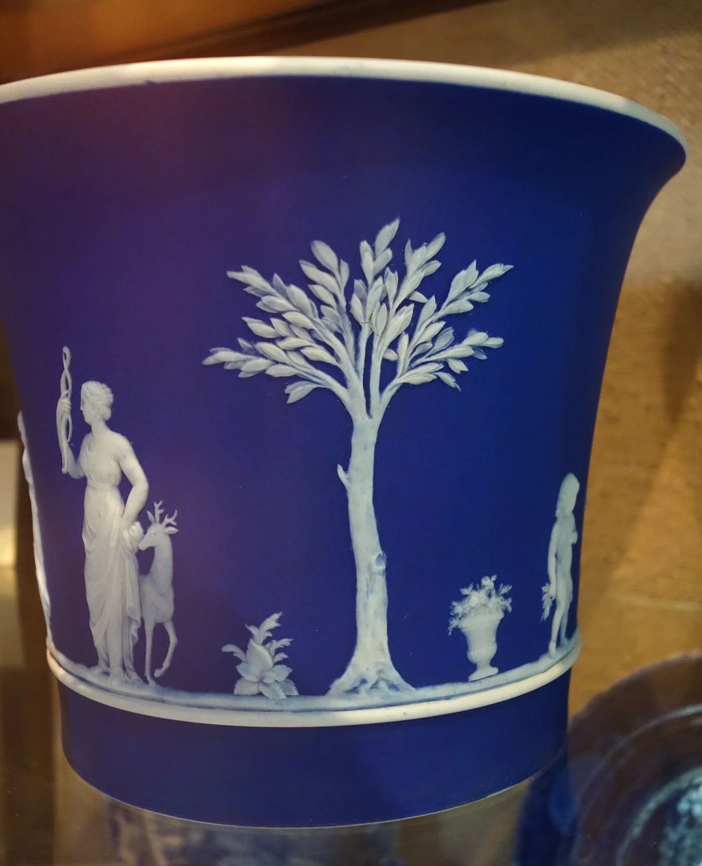 Dark blue Wedgwood jasper cache-pot seen from slightly above, with a white rim line visible where the coloured slip ends at the mouth